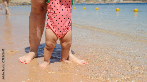 close up photo of father holding in his arms his little baby girl and walking in the garden of a hotel at a tropic destination