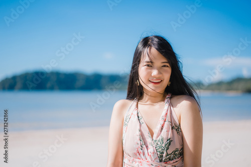 Beautiful young Asian woman happy relax walking on beach near sea. Lifestyle women travel on beach concept.