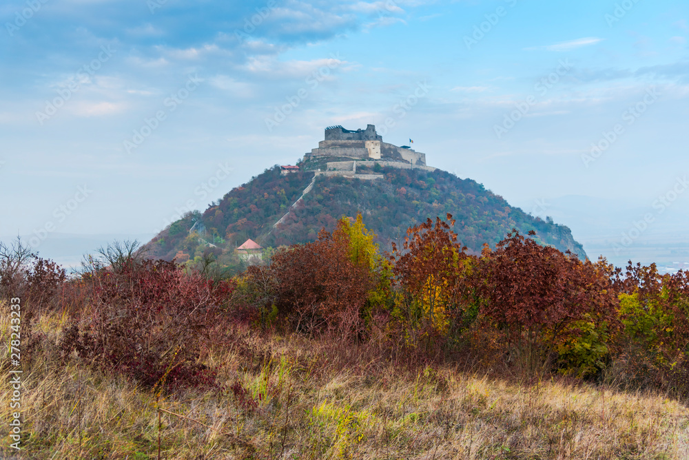 Fototapeta premium Autumn landscape with Deva citadel, view from the hill