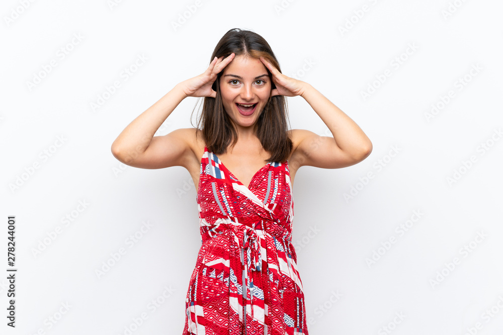 Caucasian girl in red dress over isolated white wall with surprise expression Caucasian girl in red dress over isolated white wall with surprise expression