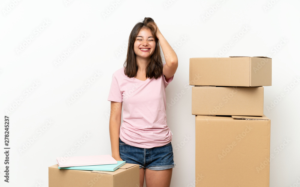 Young girl moving in new home among boxes laughing Young girl moving in new home among boxes laughing