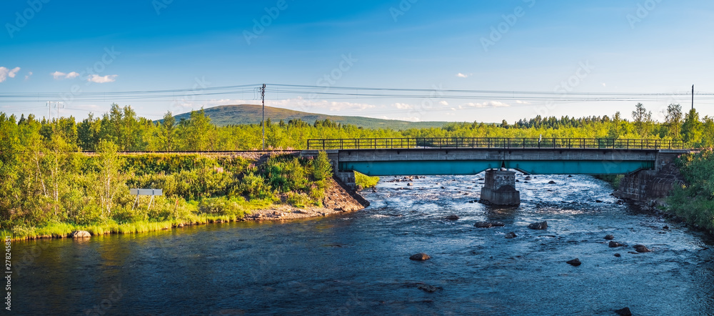 Picturesque panorama view of the railway bridge over the Rautas River near Rautas village in Kiruna municipality, Norrbotten, Sweden.