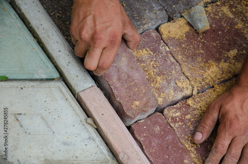 A worker is laying paving slabs