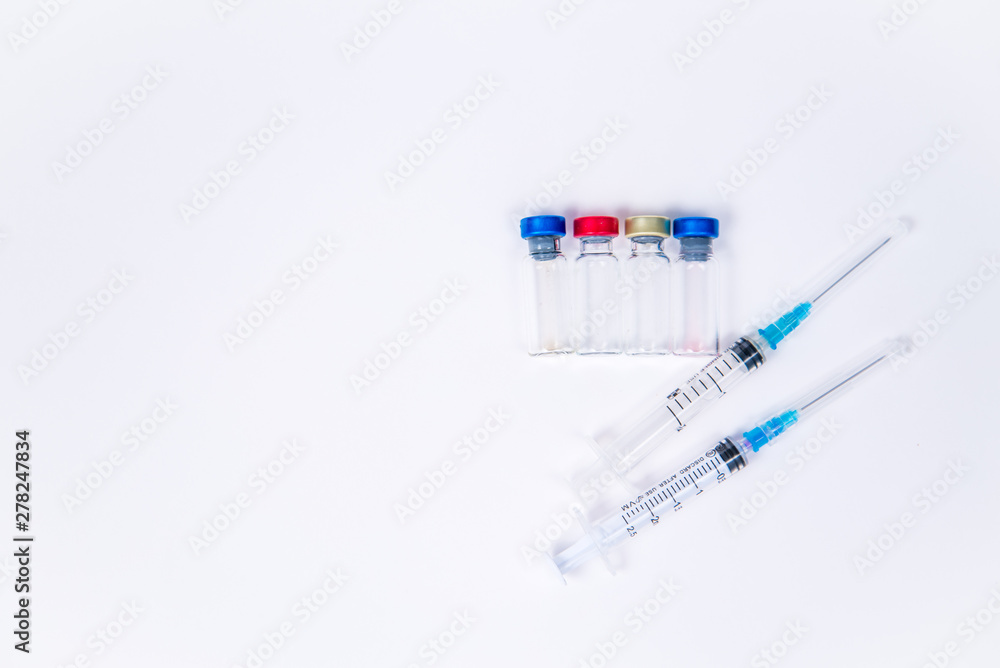 Veterinary and medical glass vials and two syringes for vaccination on a white isolated background. Liquid drug or vaccine to treat people and Pets against viruses, diseases, flu, rabies. Copy spase Veterinary and medical glass vials and two syringes for vaccination on a white isolated background. Liquid drug or vaccine to treat people and Pets against viruses, diseases, flu, rabies. Copy spase