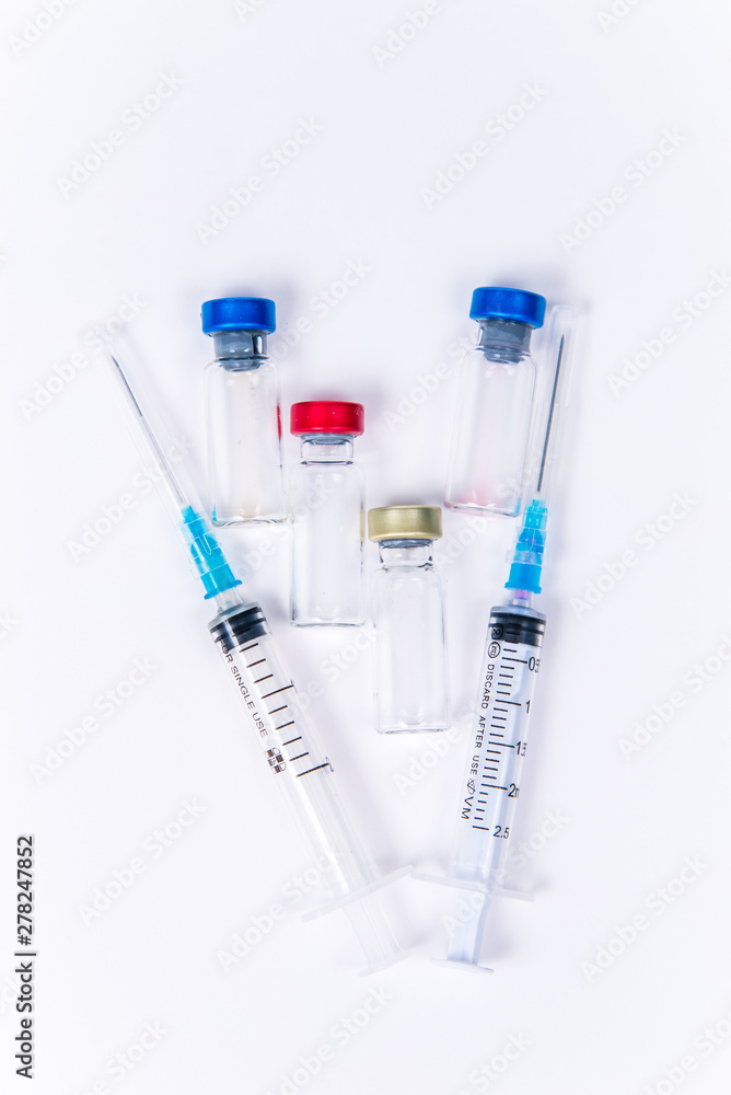 Veterinary and medical glass vials and two syringes for vaccination on a white isolated background. Liquid drug or vaccine to treat people and Pets against viruses, diseases, flu, rabies. Copy spase Veterinary and medical glass vials and two syringes for vaccination on a white isolated background. Liquid drug or vaccine to treat people and Pets against viruses, diseases, flu, rabies. Copy spase