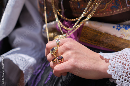 A woman dressed in typical Sardinian costume with different Sardinian ornamental golden jewels. photo