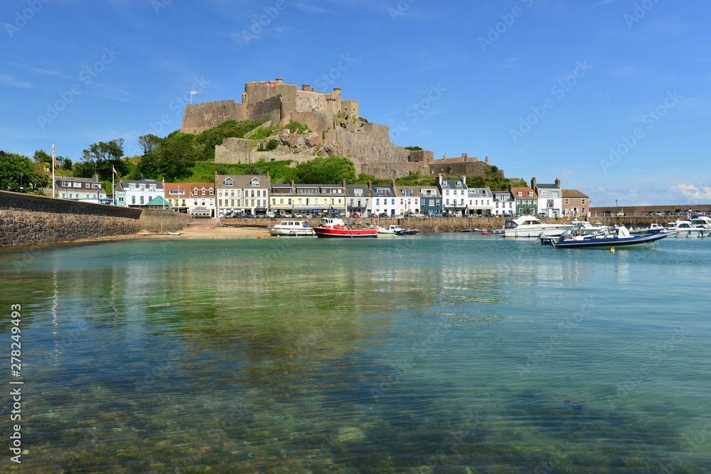 Jersey, U.K. July 13th 2019, the 12th century landmark and harbour of Gorey, Mont Orguiel Castle in the Summer at high tide.