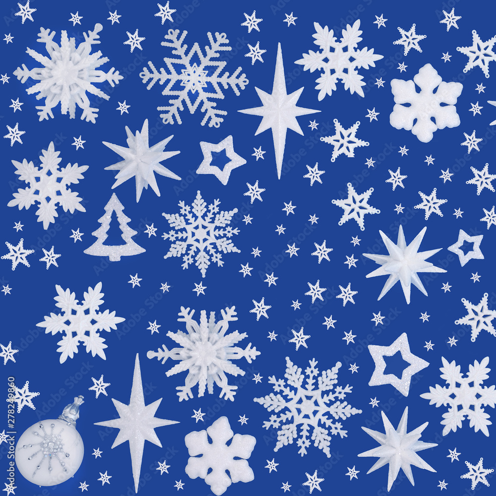 Abstract Christmas background with bauble decorations on blue background with copy space. Traditional symbols for the festive season. Abstract Christmas background with bauble decorations on blue background with copy space. Traditional symbols for the festive season.