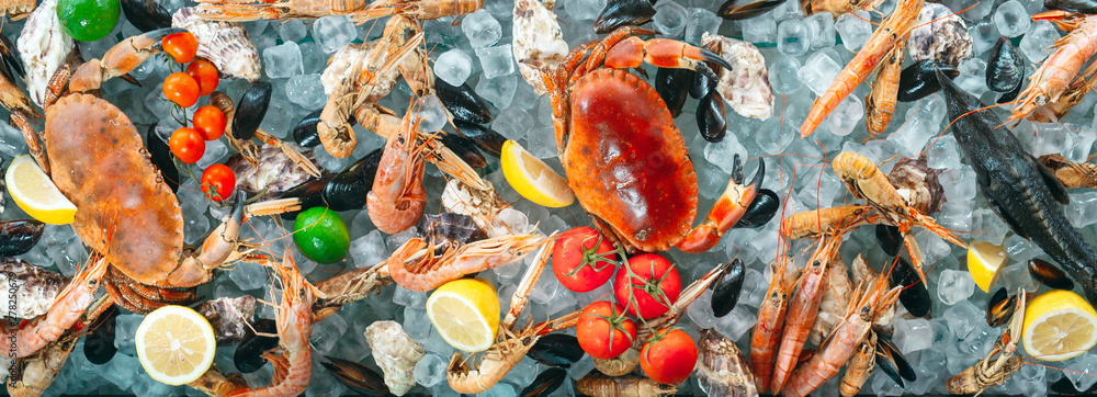 Seafood on ice. Crabs, sturgeon, shellfish, shrimp, Rapana, Dorado, on white ice.