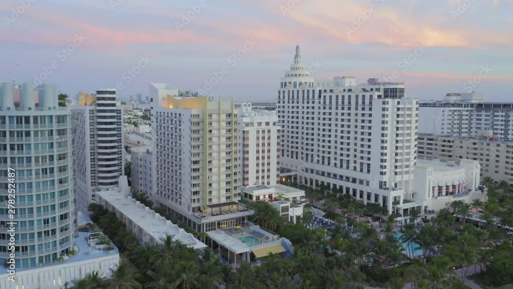 Aerial of Art Deco Hotels in the Art Deco District along the beachfront of Miami beach. In the background is downtown Miami. Florida, USA. 10 July 2019 Aerial of Art Deco Hotels in the Art Deco District along the beachfront of Miami beach. In the background is downtown Miami. Florida, USA. 10 July 2019