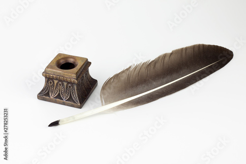 vintage metallic inkwell and old pen isolated background 