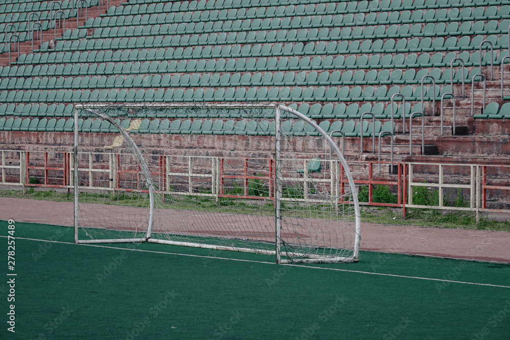 Obraz premium Soccer ball on green stadium, arena in night illuminated bright spotlights