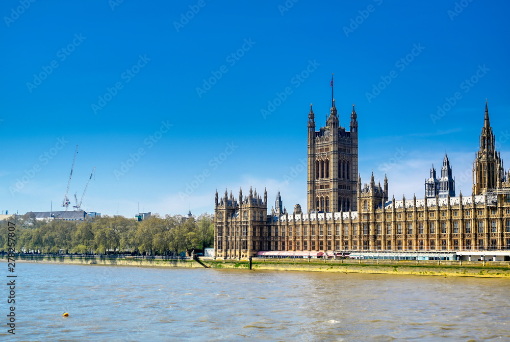 British Parliament along the River Thames on a sunny day in London, UK.