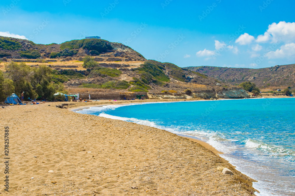 Ellinika beach with turquoise crystal waters in Kimolos island, Cyclades, Greece. Free camping at the beach Ellinika beach with turquoise crystal waters in Kimolos island, Cyclades, Greece. Free camping at the beach