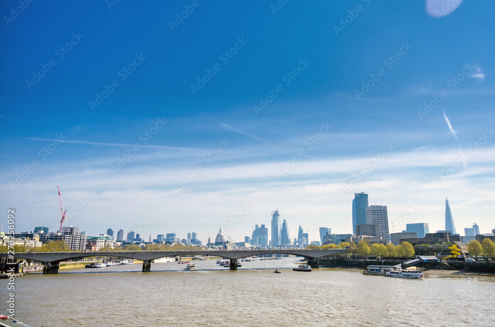 A view along the River Thames on a sunny day in London, UK.