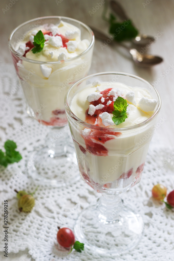 Eton mess, traditional English dessert with gooseberry, whipped cream and meringue on a light background. Rustic style. Eton mess, traditional English dessert with gooseberry, whipped cream and meringue on a light background. Rustic style.