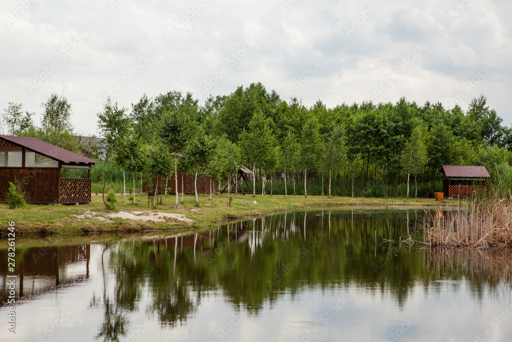 Holiday house near the lake. The concept of fishing and recreation Holiday house near the lake. The concept of fishing and recreation