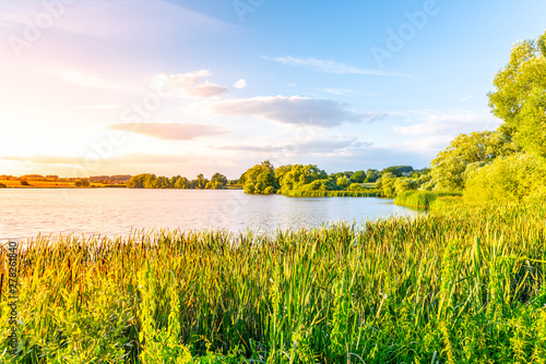 Evening sunset at calm pond and lush greenery of south bohemian landscape, Czech Republic