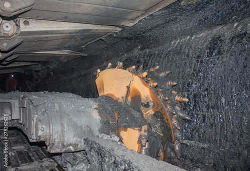 Canvas Print Coal mine excavator and miner under the ground. Industry