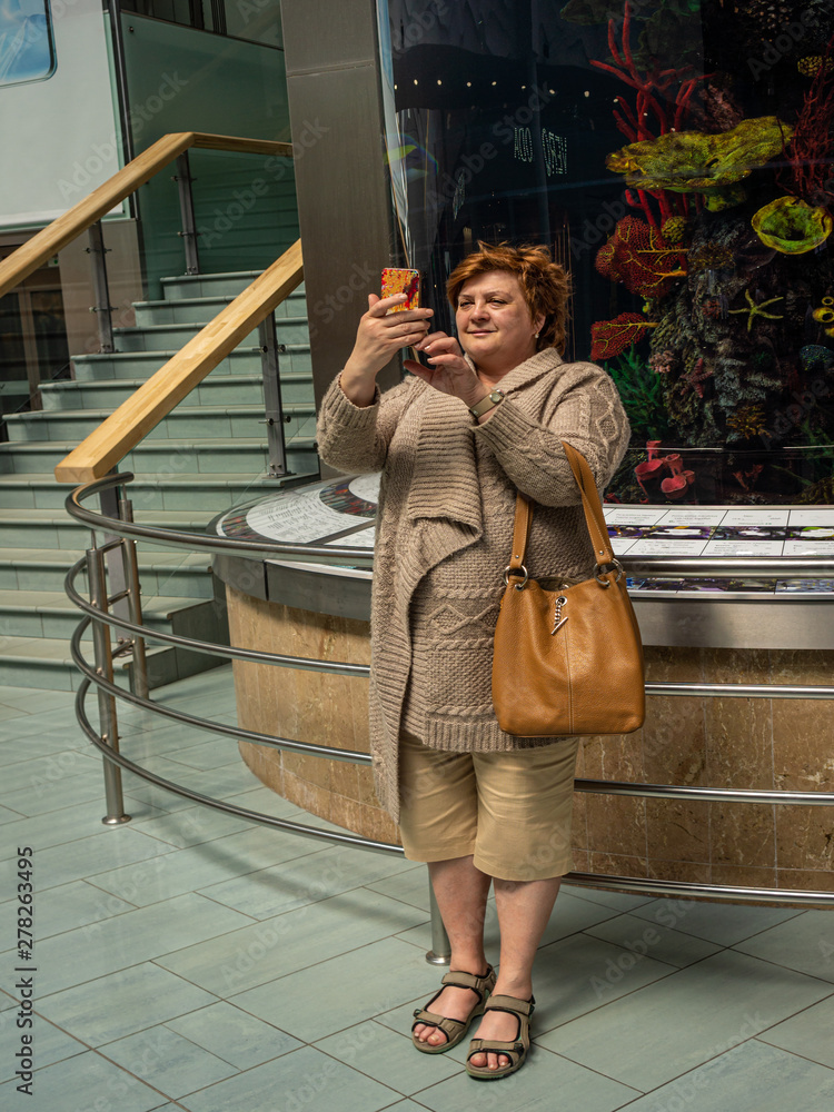 Mature woman takes a selfie in the Mall Mature woman takes a selfie in the Mall