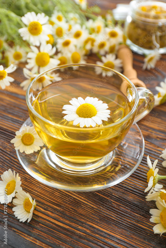 Cup of hot chamomile tea on wooden table Cup of hot chamomile tea on wooden table