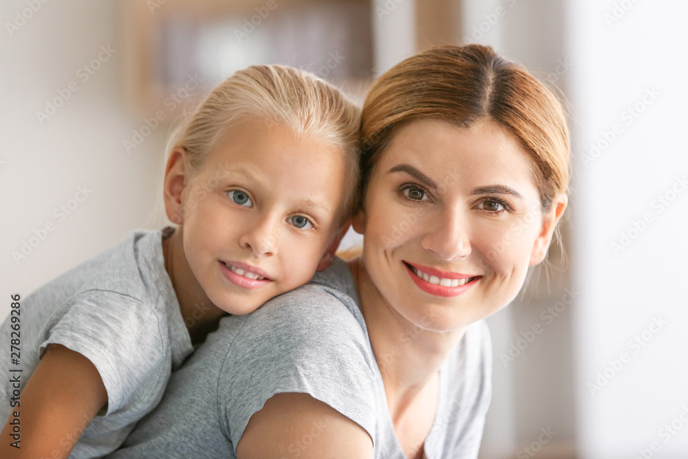 Portrait of mother with cute little daughter at home Portrait of mother with cute little daughter at home