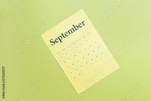 Sheet of paper calendar on color background