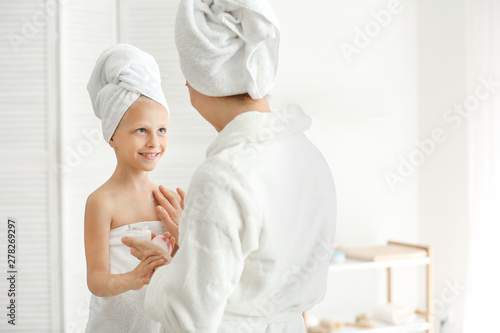 Mother applying cream onto ...