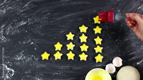 woman is painting the stars with dough by rubbing the eggs. customer satisfaction survey