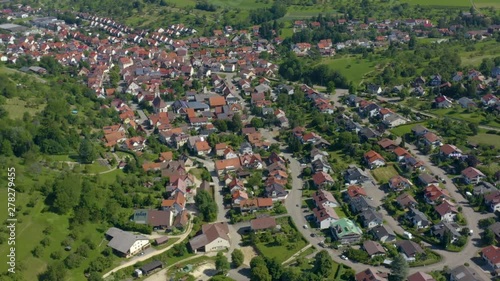 Aerial of  Neidlingen in Germany. Wide view of the town with pan to the left and tilt down.. photo