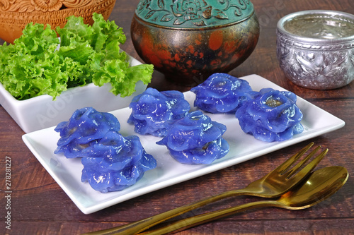Obraz na płótnie Royal Thai cuisine : Purple blue color Flower-shaped Thai dumpling (Khanom Chor Muang) Famous ancient Thai appetizers