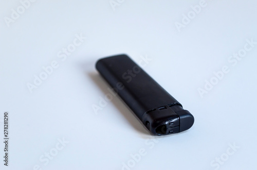 Perspective front shoot of horizontal full black lighter on white surface