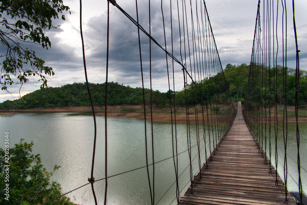 Obraz premium Hanging Bridge over the reservoir at sunset, Kang Krajarn National Park, Petchaburi, Thailand