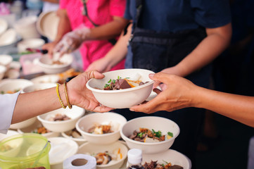 Concept of famine and social inequality : Free food for the poor and Food distribution : Sharing Food With Homeless : concept Tackling Hunger and Food