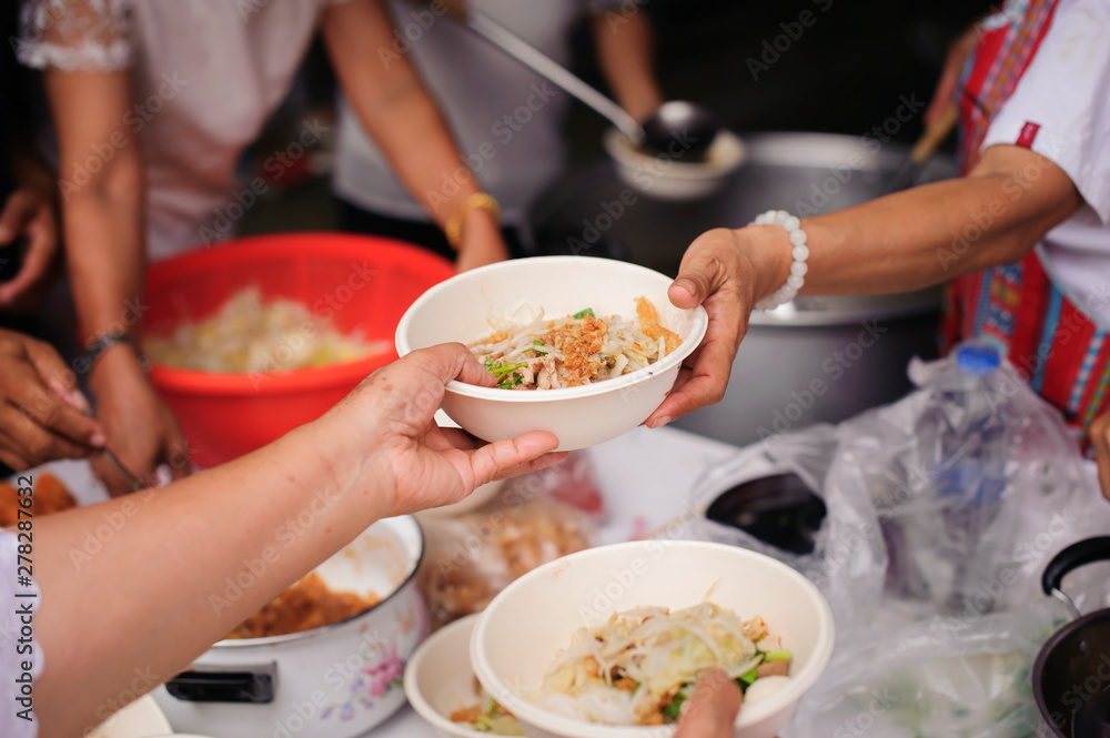 Feeding the poor to hands of a beggar : Concept of famine and social inequality : feeding food for beggar poverty concept : The society of helping to share food to the poor