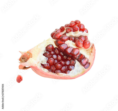 A slice of pomegranate with fallen seed on a white background, close-up