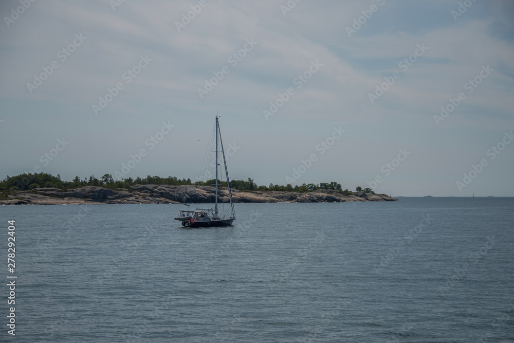 Sailing boats and the Stockholm northen archipelago a hazy summer day at the island Furusund and Yxlan Sailing boats and the Stockholm northen archipelago a hazy summer day at the island Furusund and Yxlan
