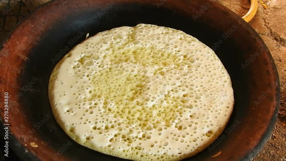 Food shot of some Homemade traditional Moroccan Baghrer in clay fryer , pancakes Baghrir or crapes with 1000 holes Food shot of some Homemade traditional Moroccan Baghrer in clay fryer , pancakes Baghrir or crapes with 1000 holes