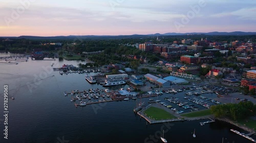 Aerial shot of boat marina. Lake Champlain Vermont and Burlington City in background. Boat docks Fly-over. photo