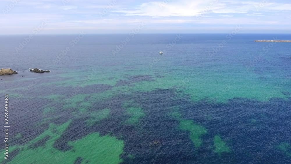Aerial, drone shot, over turquoise water, towards a boat on the Atlantic sea, on a sunny, summer morning. near Porto, in Vila do Conde, Portugal Aerial, drone shot, over turquoise water, towards a boat on the Atlantic sea, on a sunny, summer morning. near Porto, in Vila do Conde, Portugal