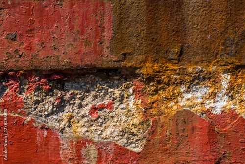 Old, worn, weathered, red painted, rusted concrete.