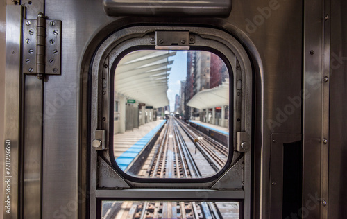view of Washington/Wabash station through the window at the back of a Chicago EL train.