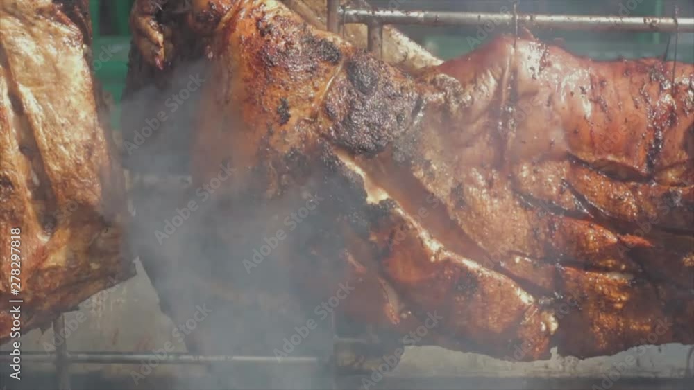 Great close-up slow-motion shot of some delicious looking suckling pig and some ribs rotating on a grill. Viola E Petisco - Brazil Great close-up slow-motion shot of some delicious looking suckling pig and some ribs rotating on a grill. Viola E Petisco - Brazil