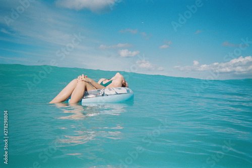 swimming with floaty in blue ocean in hawaii photo