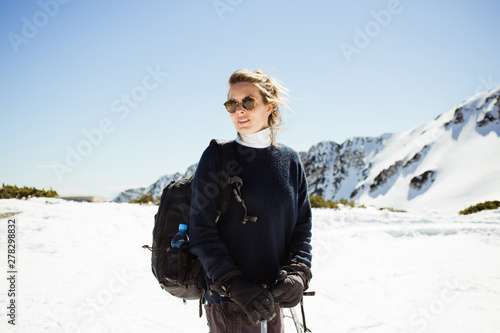 Woman with skis on top of a mountain