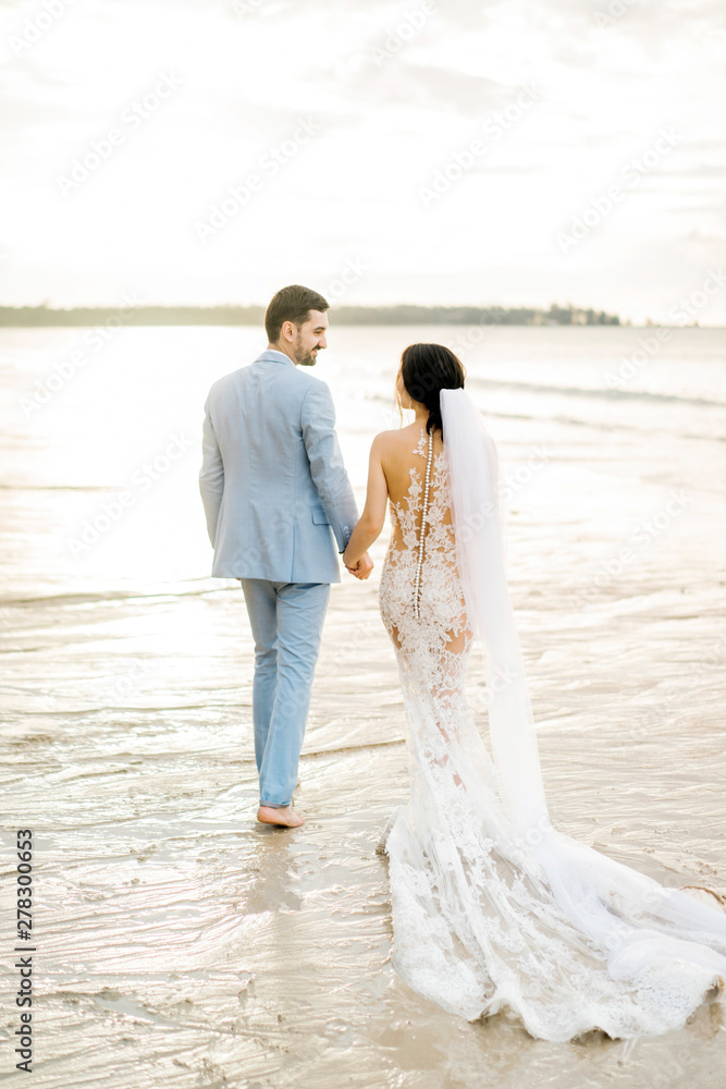 Romantic newlyweds in sunlight on beach Romantic newlyweds in sunlight on beach
