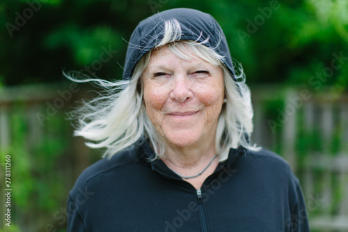 Close up portrait of an older woman wearing a hoodie photo