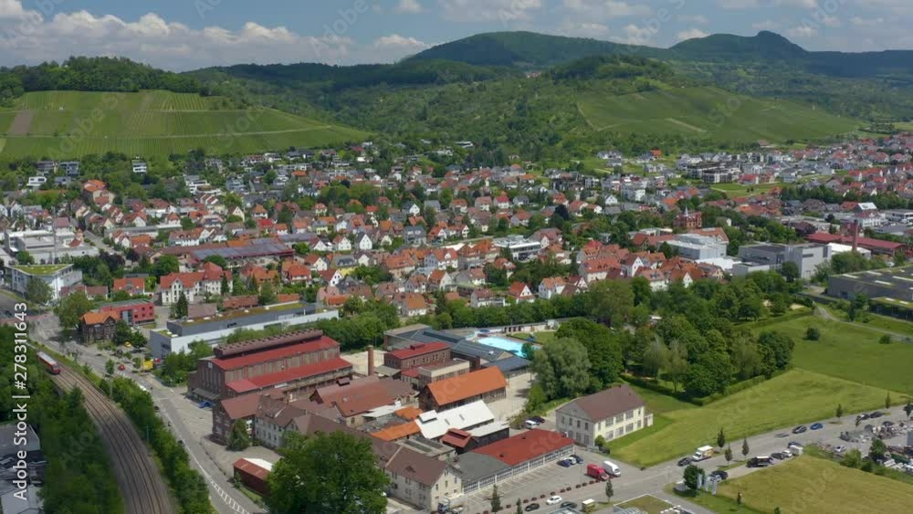Aerial view of the city Metzingen in Germany. Camera rotates right and pans left. Mountains in the background. Panorama view. Aerial view of the city Metzingen in Germany. Camera rotates right and pans left. Mountains in the background. Panorama view.