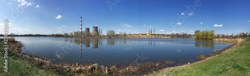 Fototapeta Naklejka Na Ścianę i Meble -  Panorama of lake with pipes of power station on shore