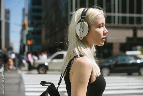 Woman listening to music in the city